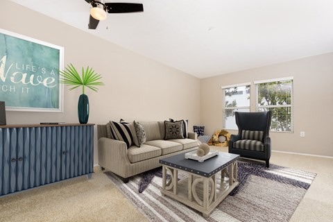 a living room with a couch and a chair and a coffee table